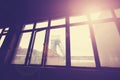 Vintage toned coal mine pithead seen through windows.