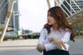 Vintage toned image of attractive young Asian business woman thinking and dreaming about something at city background. Royalty Free Stock Photo