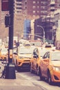 Vintage toned image of Line of NYC yellow taxicabs on street in Manhattan