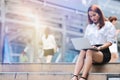 Vintage toned image of young business woman using laptop for job at outside office. Internet of things concept Royalty Free Stock Photo