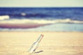 Vintage toned message in a bottle on beach, shallow depth of fie Royalty Free Stock Photo