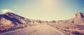 Vintage toned panoramic photo of desert road. Royalty Free Stock Photo