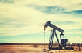 Vintage toned picture of an oil pump jack, Texas. Royalty Free Stock Photo