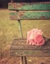 Vintage toned picture of pink flowers bouquet on a wooden old bench Royalty Free Stock Photo