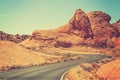 Vintage toned picture of a scenic winding road, USA Royalty Free Stock Photo