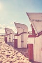 Wicker hooded basket chairs on a beach at sunset. Royalty Free Stock Photo