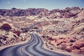 Vintage toned picture of a winding desert road. Royalty Free Stock Photo