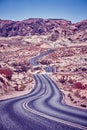 Vintage toned picture of a winding desert road. Royalty Free Stock Photo