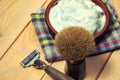 Vintage toned shaving accessories, razor blade and brush on the wooden table Royalty Free Stock Photo