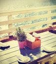 Vintage toned table setting on pier at sunset. Royalty Free Stock Photo