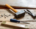 Vintage tools old used, hammer, plincers and nail on wood, work bench table Royalty Free Stock Photo