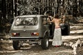 Vintage topless girl in front of the car