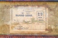 Vintage torn paper luggage label with text delivered luggage on an old suitcase