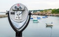 Vintage tower viewer overlooking a small harbor with sailboats