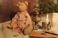 Stylish toy vintage teddy bear in pink dress, kerosene lamp or lantern, lit candle and open book. Royalty Free Stock Photo