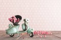 Vintage toy blue mototrcycle with bunch of pink flowers Royalty Free Stock Photo