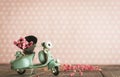 Vintage toy blue mototrcycle with bunch of pink flowers Royalty Free Stock Photo