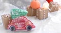 Vintage toy car with fir tree and gift boxes on snowy background. Christmas decoration for holidays sale. Royalty Free Stock Photo