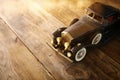 Vintage toy car over wooden table Royalty Free Stock Photo