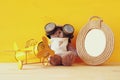 vintage toy plane and cute teddy bear next to empty frame Royalty Free Stock Photo