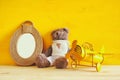 vintage toy plane and teddy bear next to empty frame Royalty Free Stock Photo
