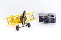 Vintage toy plane with vintage travel camera isolated on white travel concept Royalty Free Stock Photo