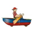 Vintage toy rowing boat with little rower isolated on white