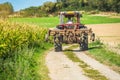 old tractor equipped with a plow in action in a field close-up Royalty Free Stock Photo