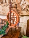 vintage traditional spinning wheel, distaff with yarn in wooden home interior Royalty Free Stock Photo