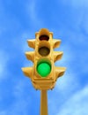 Vintage traffic light with green light on blue sky background Royalty Free Stock Photo