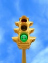 Vintage traffic light with green GO light on blue sky background Royalty Free Stock Photo