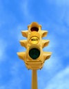 Vintage traffic light with yellow WAIT light on blue sky background Royalty Free Stock Photo