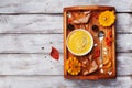 Vintage tray with autumn pumpkin soup decorated sesame seeds and thyme leaf in white bowl on rustic wooden table top view.