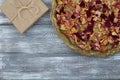 Vintage tray with petals of dried rose flowers, gift box wrapped in kraft paper on a gray table. Flat styling. Copy Royalty Free Stock Photo