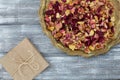 Vintage tray with petals of dried rose flowers, gift box wrapped in kraft paper on a gray table. Flat styling. Copy space for text Royalty Free Stock Photo