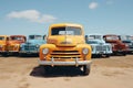 Vintage trucks and colorful cars in parking lot, front view of yellow, blue, and red vehicles Royalty Free Stock Photo