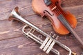 Vintage trumpet and cello on wooden background. Royalty Free Stock Photo