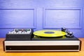 Vintage turntable vinyl record player with yellow vinyl Royalty Free Stock Photo