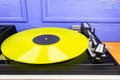 Vintage turntable vinyl record player with yellow vinyl Royalty Free Stock Photo