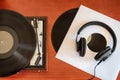 Vintage turntable with vinyls and headphones