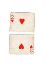A vintage two of hearts playing card torn in half. Royalty Free Stock Photo