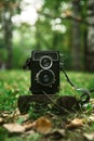 Vintage two-lens camera in the wood, selective focus Royalty Free Stock Photo