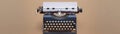 Vintage typewriter with a blue body and beige keys, blank sheet ready to use. Light being background, Royalty Free Stock Photo