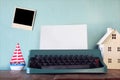 Vintage typewriter with blank page and empty photo frame