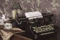 Vintage old style typewriter on the retro table. Retro interior with the old furniture and vintege mirror on the wall