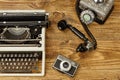 Vintage typewriter,camera and an old telephone on wooden table a Royalty Free Stock Photo