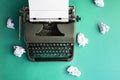 Vintage typewriter and crumpled paper sheets. Writer and blogger concept. Top view, flat lay Royalty Free Stock Photo