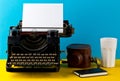 Vintage typewriter with empty, blank sheet of paper, camera, cup Royalty Free Stock Photo