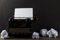 Vintage typewriter with empty, blank sheet of paper and crumbled
