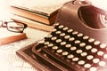 Vintage typewriter, old books on table Royalty Free Stock Photo